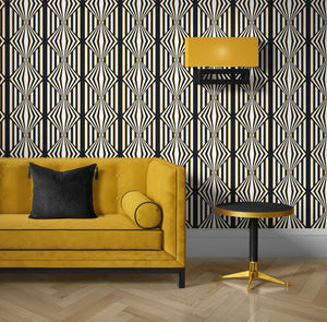 Deco Prism wallpaper by Liberty James Studio in black and gold, art deco wave stripes behind a sofa in a living room