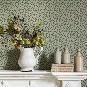 Edera wallpaper by Deus ex Gardenia in cream and green, trailing ivy leaves above a sideboard