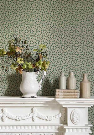 Edera wallpaper by Deus ex Gardenia in cream and green, trailing ivy leaves above a sideboard