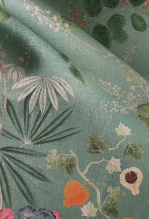 Little Eden linen by Deus ex Gardenia in sage green, draped close-up of lush leaves and fruit