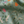 Little Eden linen by Deus ex Gardenia in sage green, draped, showing lush leaves and fruit