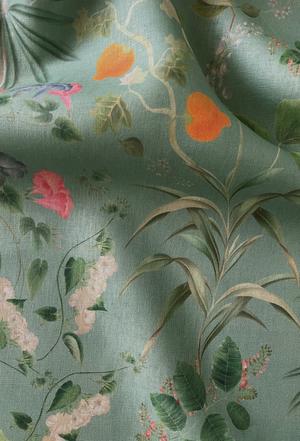 Little Eden linen by Deus ex Gardenia in sage green, draped, showing lush leaves and fruit