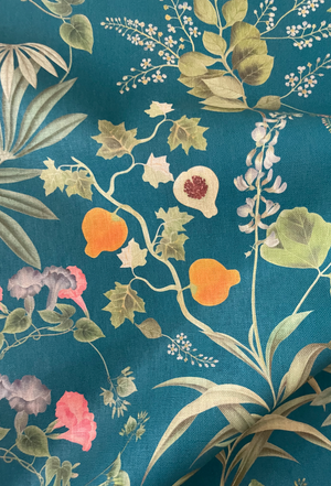 Little Eden linen by Deus ex Gardenia in teal, draped close-up of lush leaves and fruit