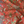 Little Eden linen by Deus ex Gardenia in orange, draped, showing lush leaves and fruit