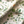 Little Eden linen by Deus ex Gardenia in cream and green, draped close-up of lush leaves and fruit