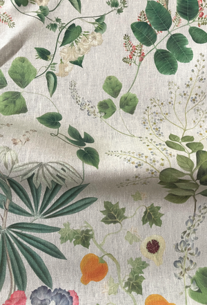 Little Eden linen by Deus ex Gardenia in cream and green, in soft folds showing lush leaves and fruit