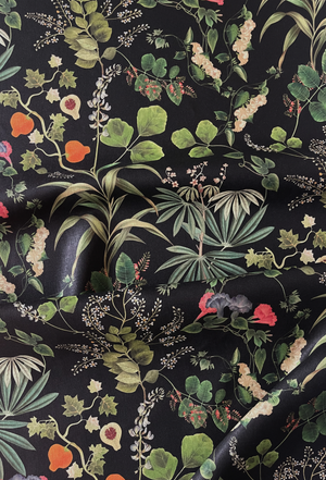 Little Eden linen by Deus ex Gardenia in black, flat sample of lush leaves and fruit