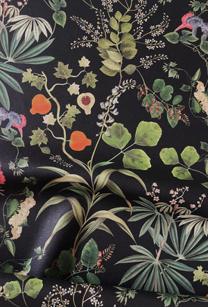 Little Eden linen by Deus ex Gardenia in black, draped, showing lush leaves and fruit