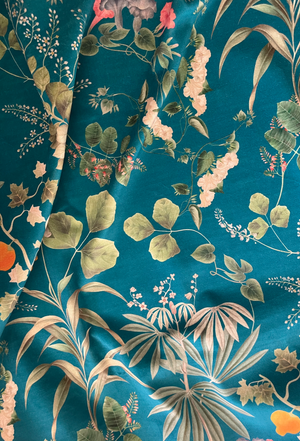 Little Eden velvet by Deus ex Gardenia in teal, draped close-up of lush leaves and fruit
