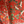 Little Eden velvet by Deus ex Gardenia in orange, draped, showing lush leaves and fruit