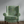 Little Eden velvet by Deus ex Gardenia in sage green, lush leaves and fruit upholstered on an armchair