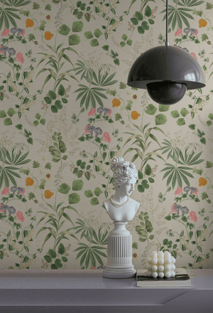 Little Eden wallpaper by Deus ex Gardenia in cream and green, lush leaves and fruit above a sideboard