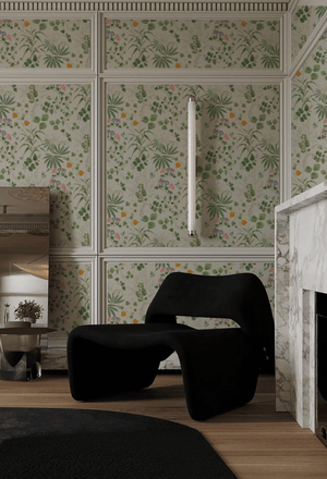Little Eden wallpaper by Deus ex Gardenia in cream and green, lush leaves and fruit behind a sofa in a living room