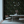 Little Eden wallpaper by Deus ex Gardenia in black, lush leaves and fruit in a dining area