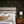 Little Eden wallpaper by Deus ex Gardenia in black, lush leaves and fruit in a bedroom