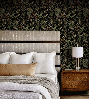 Little Eden wallpaper by Deus ex Gardenia in black, lush leaves and fruit in a bedroom