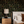 Little Eden wallpaper by Deus ex Gardenia in black, lush leaves and fruit behind a bed