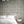 Little Eden wallpaper by Deus ex Gardenia in cream and green, lush leaves and fruit on a bedroom wall