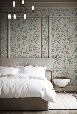 Little Eden wallpaper by Deus ex Gardenia in cream and green, lush leaves and fruit on a bedroom wall