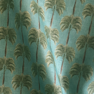 Little Palma linen by Deus ex Gardenia in sage green, draped, showing rows of palm trees