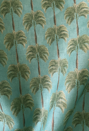 Little Palma linen by Deus ex Gardenia in sage green, in soft folds showing rows of palm trees