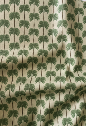 Little Palma linen by Deus ex Gardenia in beige and green, in soft folds showing rows of palm trees