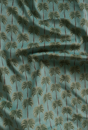 Little Palma velvet by Deus ex Gardenia in sage green, draped, showing rows of palm trees