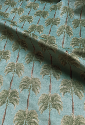 Little Palma velvet by Deus ex Gardenia in beige and green, in soft folds showing rows of palm trees