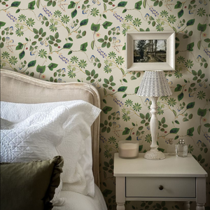 Meadowlane wallpaper by Deus ex Gardenia in cream and green, trailing meadow flowers in a bedroom