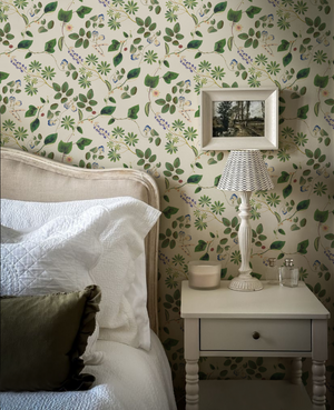 Meadowlane wallpaper by Deus ex Gardenia in cream and green, trailing meadow flowers in a bedroom