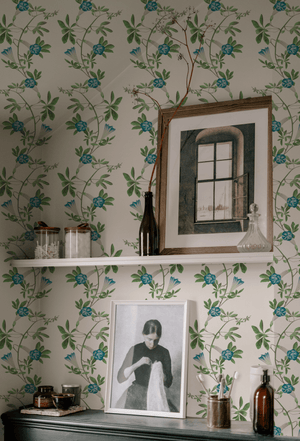 Midsummer wallpaper by Deus ex Gardenia in cream and blue, trailing bellflowers above a sideboard