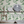 Midsummer wallpaper by Deus ex Gardenia in charcoal and green, trailing bellflowers behind a console table