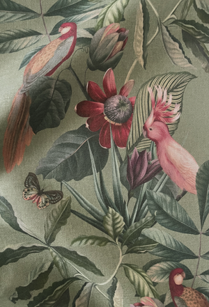 Passiflora linen by Deus ex Gardenia in sage green, in soft folds showing parrots and passion flowers