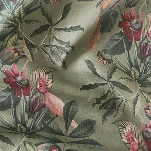 Passiflora linen by Deus ex Gardenia in sage green, draped, showing parrots and passion flowers
