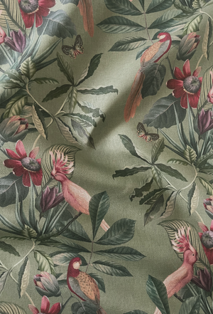 Passiflora linen by Deus ex Gardenia in sage green, draped, showing parrots and passion flowers