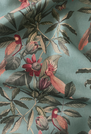 Passiflora linen by Deus ex Gardenia in teal, draped, showing parrots and passion flowers