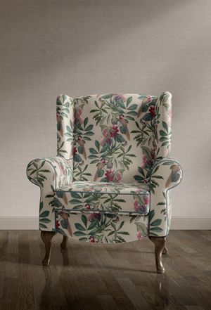 Passiflora velvet by Deus ex Gardenia in cream, parrots and passion flowers on an upholstered chair