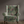 Passiflora velvet by Deus ex Gardenia in sage green, parrots and passion flowers upholstered on an armchair