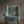 Passiflora velvet by Deus ex Gardenia in teal, parrots and passion flowers covering an armchair