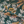 Resplendent Woods linen by Deus ex Gardenia in dark green, in soft folds showing peacocks and pheasants in trees