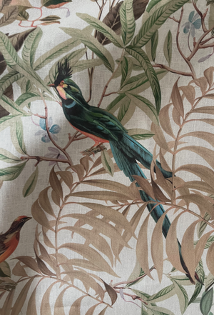 Resplendent Woods linen by Deus ex Gardenia in cream, in soft folds showing peacocks and pheasants in trees