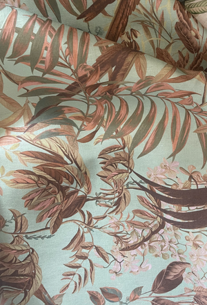 Resplendent Woods linen by Deus ex Gardenia in teal, in soft folds showing peacocks and pheasants in trees