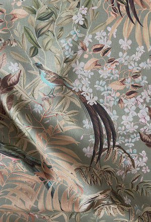 Resplendent Woods linen by Deus ex Gardenia in sage green, draped, showing peacocks and pheasants in trees