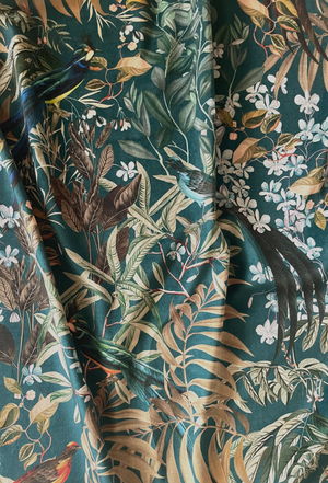 Resplendent Woods velvet by Deus ex Gardenia in dark green, draped, showing peacocks and pheasants in trees