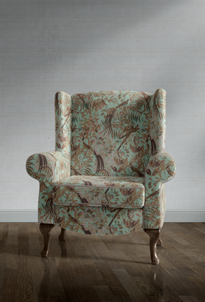 Resplendent Woods velvet by Deus ex Gardenia in teal, peacocks and pheasants in trees covering an armchair