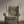 Resplendent Woods velvet by Deus ex Gardenia in sage green, peacocks and pheasants in trees upholstered on an armchair