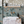 Wild Ivy wallpaper by Deus ex Gardenia in teal, climbing ivy in a bathroom
