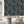 Wild Ivy wallpaper by Deus ex Gardenia in navy, climbing ivy behind a dining table