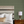 Little Palma wallpaper by Deus ex Gardenia in beige and green, rows of palm trees in a bedroom