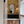 Resplendent Woods in India superwide wallpaper by Deus ex Gardenia in yellow on a bathroom wall